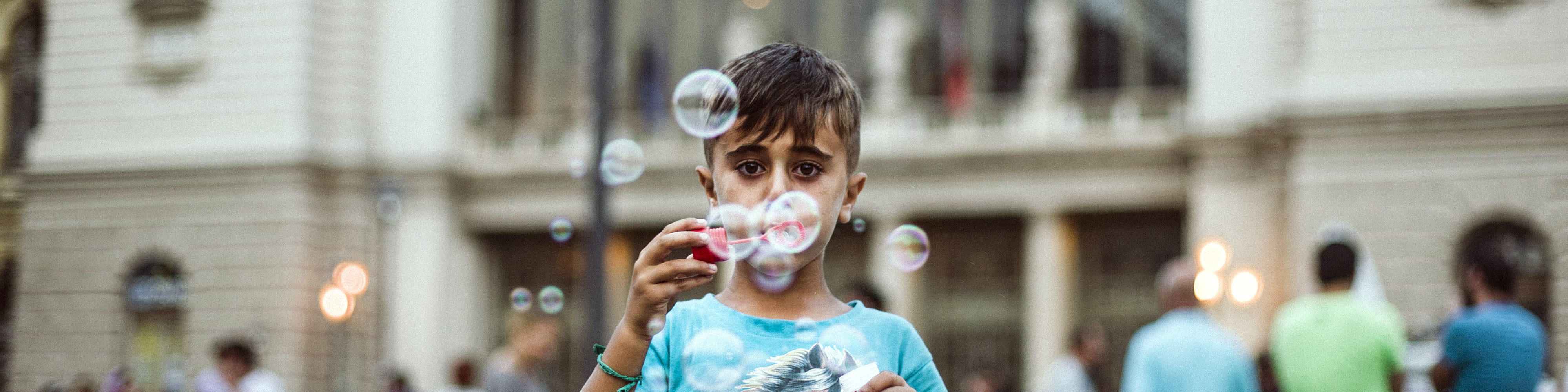 Syrian refugee playing with soap bubbles in Hungary.